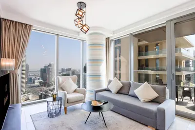 a living room with a couch and a large window at Spacious 1BR with Open Views Boulevard Point Near Dubai Mall in Dubai