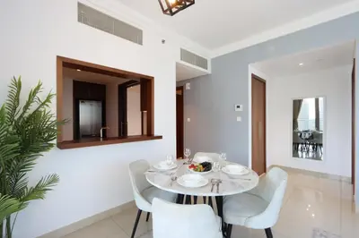 a dining room with a table and chairs and a mirror at Spacious 1BR with Open Views Boulevard Point Near Dubai Mall in Dubai