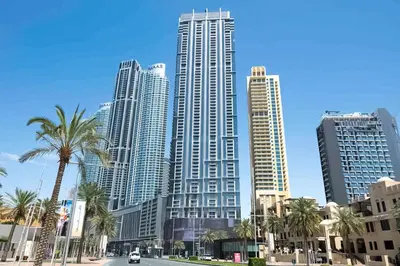 a group of tall buildings in a city with palm trees at Spacious 1BR with Open Views Boulevard Point Near Dubai Mall in Dubai
