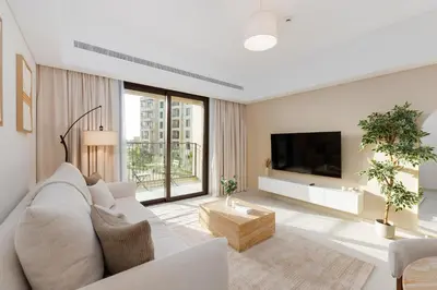 a living room with a white couch and a tv at Al Jazi 2, Madinat Jumeirah Living - Mint Stay in Dubai