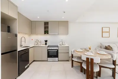 a kitchen and dining room with a table and chairs at Al Jazi 2, Madinat Jumeirah Living - Mint Stay in Dubai