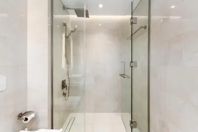 a shower with a glass door in a bathroom at Al Jazi 2, Madinat Jumeirah Living - Mint Stay in Dubai
