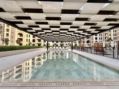 a swimming pool in the middle of a building at Al Jazi 2, Madinat Jumeirah Living - Mint Stay in Dubai