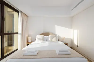 a bedroom with a large white bed with two pillows at Al Jazi 2, Madinat Jumeirah Living - Mint Stay in Dubai