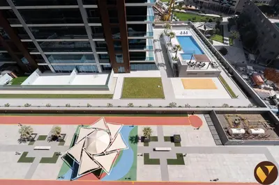 an overhead view of a building with a pool at Vogue Elite Business Bay Residence Close to Burj Khalifa and Dubai Mall, Studio Apartment with Balcony, City and Canal View, Access to all Amenities in Dubai
