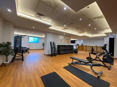 a gym with treadmills and exercise equipment in a room at Vogue Elite Business Bay Residence Close to Burj Khalifa and Dubai Mall, Studio Apartment with Balcony, City and Canal View, Access to all Amenities in Dubai