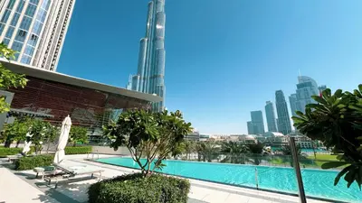 a swimming pool with a view of the city at INCREDIBLE BURJ KHALIFA & DUBAI FOUNTAIN Views - 2 BR Luxury Apartment - Sanctuary Stays in Dubai