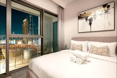 a bedroom with a bed and a large window at Luxury Apartment in Burj Vista with Burj Khalifa View in Dubai