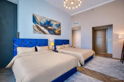 two beds in a bedroom with a blue headboard at Luxury Apartment in Burj Vista with Burj Khalifa View in Dubai