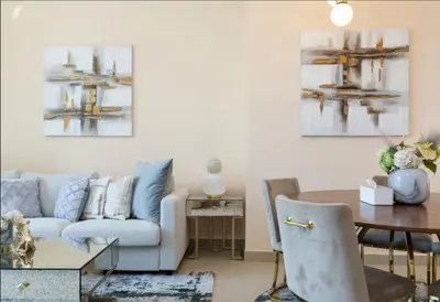 a living room with a couch and a table at Luxury Apartment in Burj Vista with Burj Khalifa View in Dubai