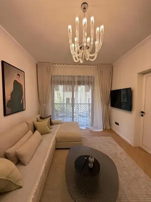 a living room with a couch and a chandelier at Yansoon 4 , Old Town Downtown in Dubai