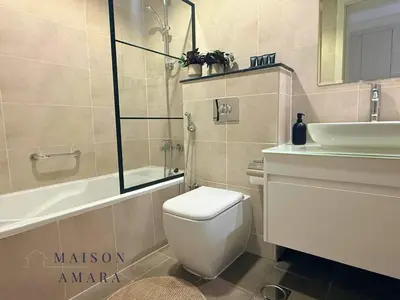 a bathroom with a toilet and a sink and a tub at Modern Luxurious Studio Golf View Damac Community in Dubai