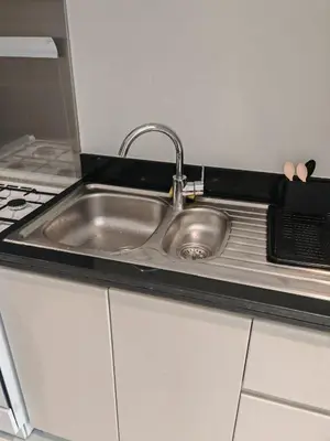 a stainless steel sink in a small kitchen at Modern Luxurious Studio Golf View Damac Community in Dubai