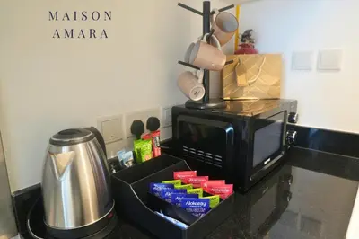 a kitchen counter with a microwave and a coffee pot at Modern Luxurious Studio Golf View Damac Community in Dubai