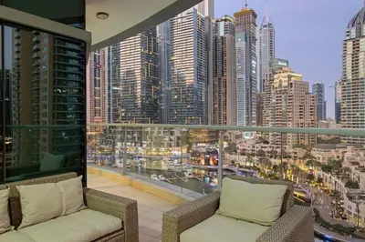 a balcony with two chairs and a view of a city at FIRST CLASS 2BR Spectacular Marina Views in Dubai
