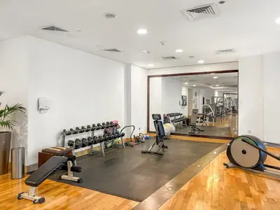 a gym with several treadmills and exercise machines at FIRST CLASS 2BR Spectacular Marina Views in Dubai
