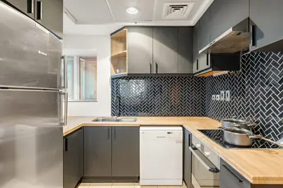 a kitchen with stainless steel appliances and wooden counters at FIRST CLASS 2BR Spectacular Marina Views in Dubai