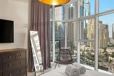 a bedroom with a large window with a view of a city at FIRST CLASS 2BR Spectacular Marina Views in Dubai