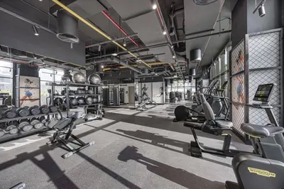 a gym with several treadmills and weights at LUX 2 BDR apartment - Burj Khalifa view in Dubai