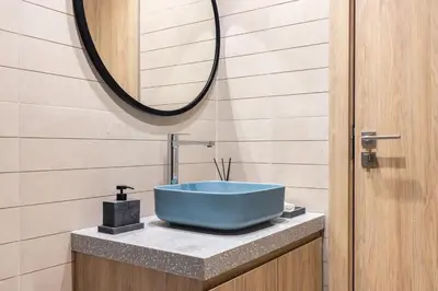 a bathroom with a blue sink and a mirror at LUX 2 BDR apartment - Burj Khalifa view in Dubai