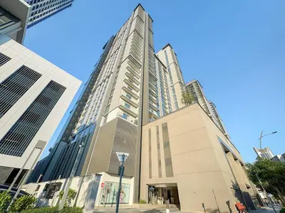 a tall building on a city street with at FIRST CLASS 1BR Urban Serenity Near Downtown in Dubai