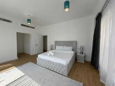 a white bedroom with a large white bed in it at 2BR Apartment in JBR The Walk in Dubai