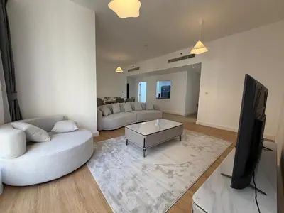 a living room with a couch and a tv at 2BR Apartment in JBR The Walk in Dubai
