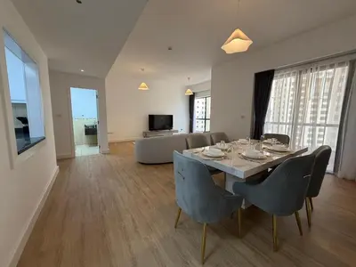 a dining room with a table and chairs and a couch at 2BR Apartment in JBR The Walk in Dubai