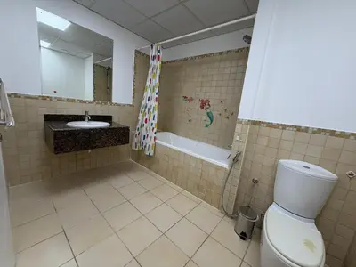 a bathroom with a toilet and a sink and a tub at 2BR Apartment in JBR The Walk in Dubai