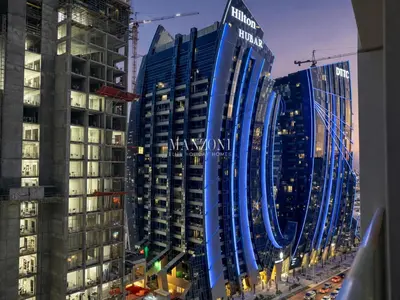 a view of some buildings in a city at night at Business Bay Luxury Apt - 5min Burj Khalifa, Mall & Metro in Dubai