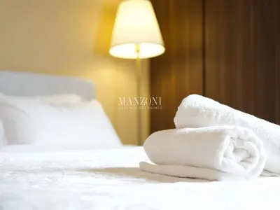 a pile of towels sitting on top of a bed at Business Bay Luxury Apt - 5min Burj Khalifa, Mall & Metro in Dubai