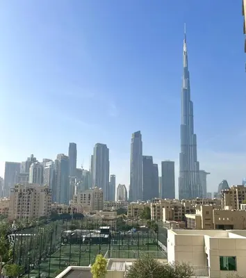 a view of a city skyline with a tall skyscraper at Premium Downtown 1BD Apartment Burj Khalifa View 9 Mins walk Dubai Mall in Dubai