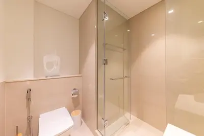 a bathroom with a shower and a toilet at Luxury 3BR Burj View in Downtown Dubai in Dubai