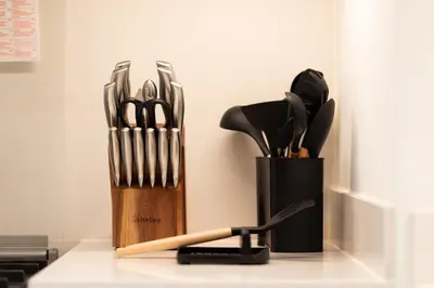 a kitchen counter with a knife block with utensils at Luxury 3BR Burj View in Downtown Dubai in Dubai