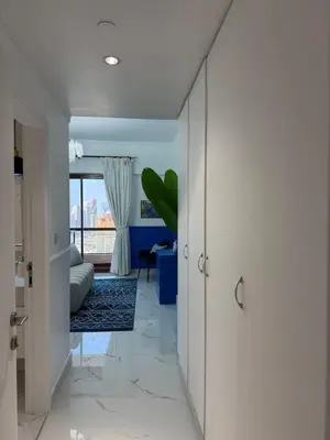 a hallway with a door leading to a living room at Sea View Spacious Apartment in JBR in Dubai