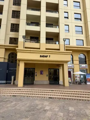 a large building with the entrance to a building at Sea View Spacious Apartment in JBR in Dubai