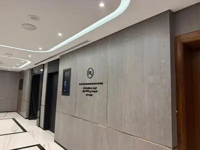 a hallway in a building with a sign on the wall at Sea View Spacious Apartment in JBR in Dubai