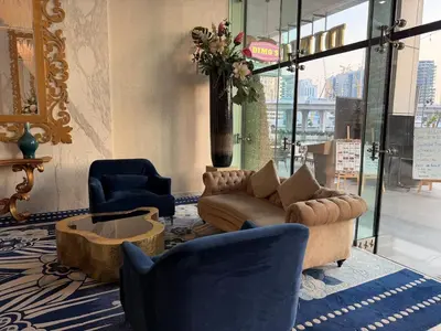 a lobby with a couch and two chairs and a table at Studio with Pool & Canal Views - Near Dubai Mall - Downtown in Dubai