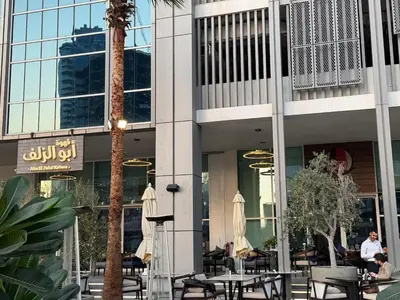 a lobby of a building with tables and chairs at Studio with Pool & Canal Views - Near Dubai Mall - Downtown in Dubai