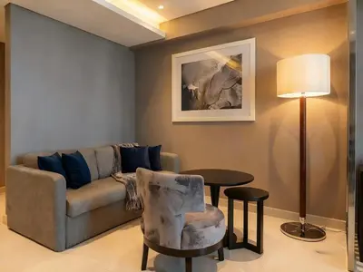 a living room with a couch and a table at Studio with Pool & Canal Views - Near Dubai Mall - Downtown in Dubai