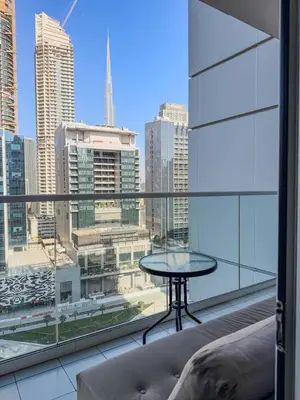 a balcony with a table and a view of a city at BurjKhalifa View | 1BR Business Bay Near Dubaimall in Dubai