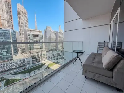 a living room with a couch and a large window at BurjKhalifa View | 1BR Business Bay Near Dubaimall in Dubai
