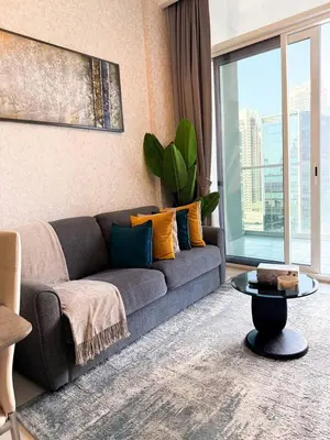 a living room with a couch and a table at BurjKhalifa View | 1BR Business Bay Near Dubaimall in Dubai