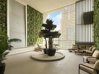 a room with a tree in the middle of a building at VayK - Luxury Living with Top Amenities 1BD in JVC in Dubai