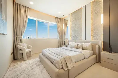 a bedroom with a bed and a large window at Elegantly crafted 5 Bedroom with Marina View in Dubai