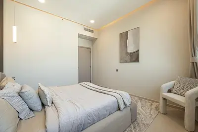 a bedroom with a bed and a chair at Elegantly crafted 5 Bedroom with Marina View in Dubai