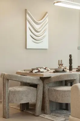 a dining room table and chairs with a picture on the wall at Elegantly crafted 5 Bedroom with Marina View in Dubai
