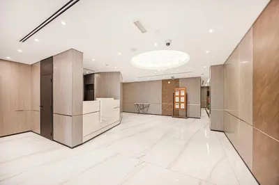 an office lobby with wooden walls and a ceiling at FiveX Premium 4BR Beachfront Living at JBR in Dubai