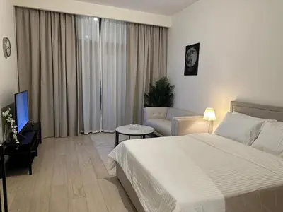 a hotel room with a bed and a couch at VESTA - Dubai Residence in Dubai