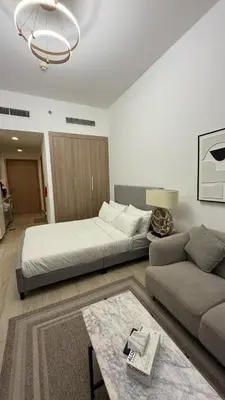 a living room with a large bed and a couch at VESTA - Dubai Residence in Dubai